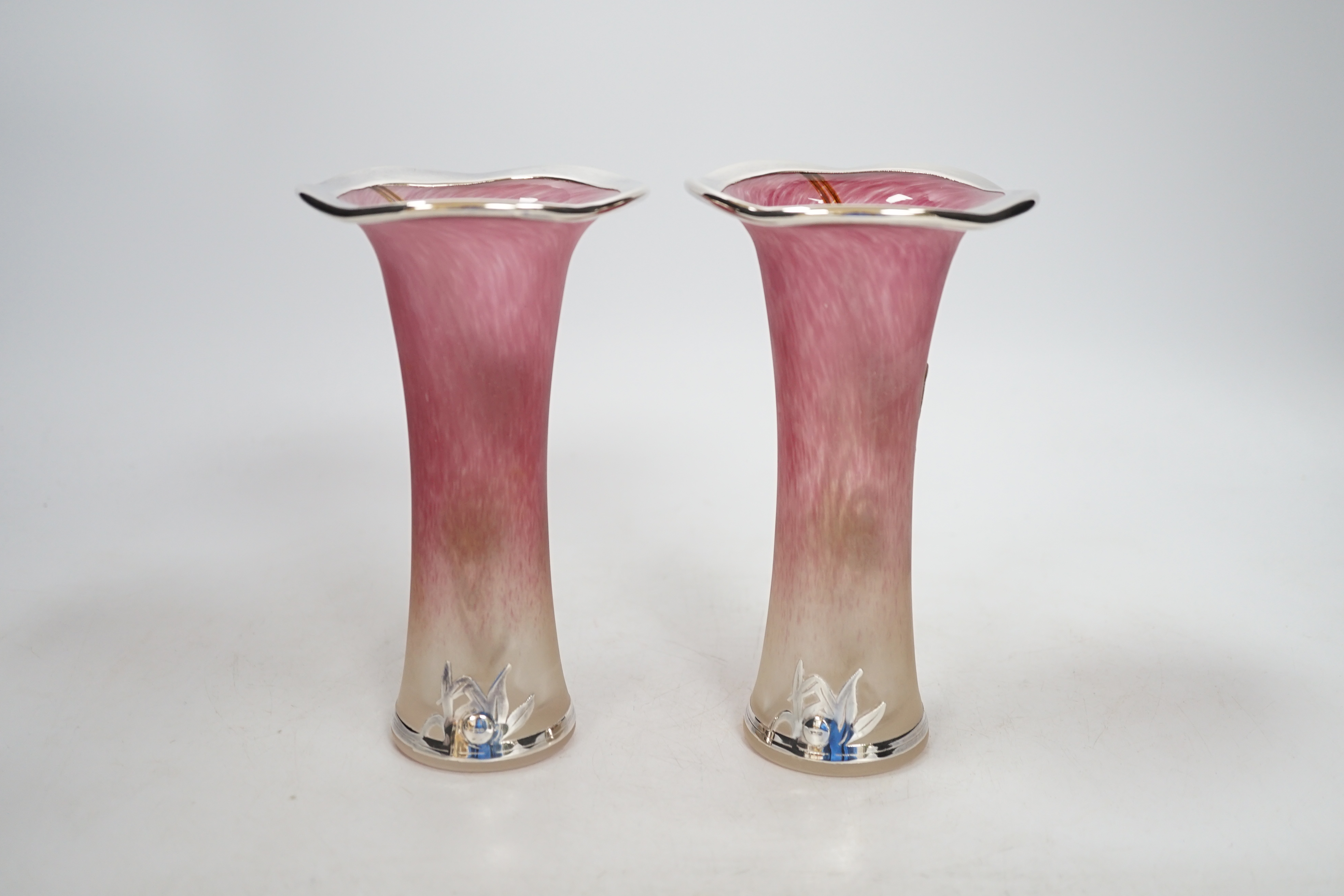 A pair of Loetz style pink tinted opaque glass specimen vases applied with silver overlaid floral decoration, height 16cm
